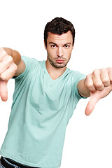 Image showing Man, hands and thumbs down standing in disappointment for fail, wrong or disagree against white studio background. Portrait of isolated young male casual model pointing thumb down on white background