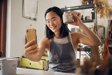 Image showing Artist woman, pottery and selfie with smile, design and product in studio to sell on internet, app or social media. Asian art girl, sculpture and smartphone with happiness, vision and artwork at desk