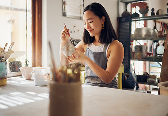 Image showing Pottery, art and creative with an asian woman in a studio for design or ceramics hobby as an artisan. Manufacturing, pattern and artist with a female potter sitting in her workshop as a sculptor