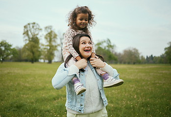 Image showing Mother, girl and sitting on shoulders in park for happiness, bonding or care in nature, walk or together outdoor. Woman, child and game on holiday, love or play for adventure at field in Toronto