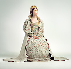 Image showing Queen, crown and vintage with a woman in studio on a gray background as ruler of the monarch during the renaissance period. History, royalty and victorian with an elegant female posing as a leader