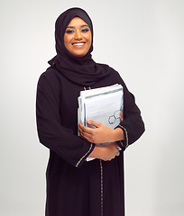 Image showing Portrait, muslim and learning with a student woman holding books in studio on a gray background for education. Islam, university and study with an islamic female at college to study on a scholarship