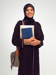 Image showing Portrait, muslim and education with a student woman holding books in studio on a gray background for learning. Islam, university and study with an islamic female at college to study on a scholarship