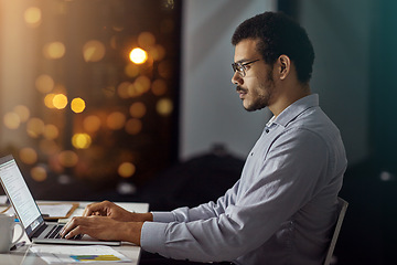 Image showing Businessman, laptop and typing in research, analysis or web design on work desk at office. Employee man sitting and working on computer in overtime at night for dedication to meet project deadline