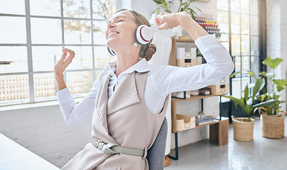 Image showing Music, headphones and senior business woman dance in office, happy and excited about small business. Earphones, dancing and elderly female celebrate in design studio, cheerful and positive at a desk