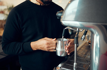 Image showing Hands, man and barista brewing coffee at cafe using machine for hot beverage, caffeine or steam. Hand of employee male steaming milk in metal jug for premium grade drink or self service at shop