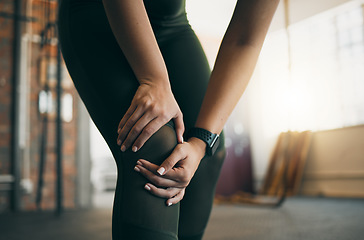 Image showing Knee injury, woman and fitness accident, pain and medical emergency, muscle strain from exercise in gym. Workout, health and wellness, athlete hands with inflammation and injured leg from training