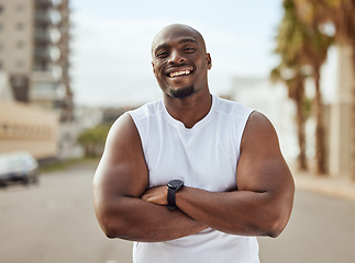 Image showing Black man, fitness and smile with arms crossed in the city for running exercise, workout or training in the outdoors. Portrait of a African American, confident and sporty male smiling in a urban town