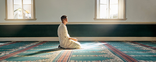 Image showing Mosque, worship and muslim man in prayer on his knees for gratitude, support or ramadan for spiritual wellness. Religion, tradition and islamic guy praying or reciting quran to allah at islam temple.