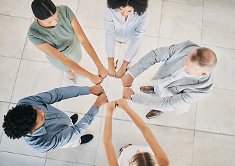 Image showing Above, business people and fist bump circle in office for teamwork, motivation and support for success. Corporate group, vision and team building in workplace with diversity, solidarity and mission