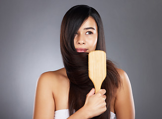 Image showing Woman, brush and hair care for beauty, wellness and self care by studio background with natural shine. Model, hair and self love with organic wooden hairbrush for sustainable cosmetics by backdrop