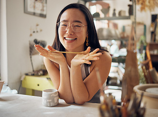 Image showing Portrait, pottery and art with an asian woman in her studio or workshop for design and creative hobby. Happy, smile or designer with a female artist working in her small business startup for ceramics