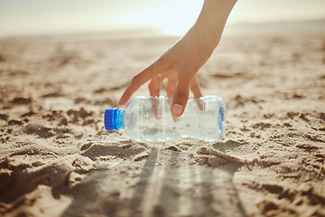 Image showing Woman, hand or picking plastic bottle in beach waste management, community service or climate change volunteering. Zoom, collection worker or trash cleaning in nature sustainability or planet recycle