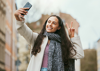 Image showing Travel, peace or happy woman taking selfie for social media in London city on a relaxing holiday vacation or weekend. Smile, hand gesture or excited girl tourist taking fun pictures with pride alone