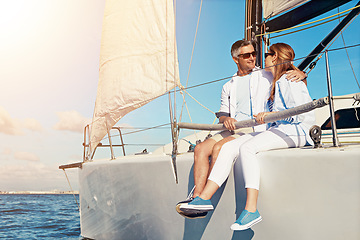 Image showing Summer, yacht and love with a couple dating on the ocean for travel, romance or honeymoon celebration. Water, luxury or cruise with a married man and woman sitting together on a boat out at sea