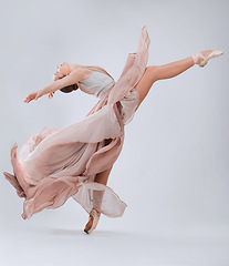 Image showing .Ballet, dance and woman with creative freedom isolated on a white background in a studio. Art, training and ballerina dancer dancing with elegance, class and beauty in a room with a backdrop.