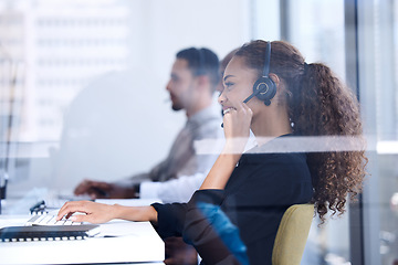 Image showing Call center, customer service and glass with a black woman consultant working in her telemarketing office. Contact us, crm and communication with a female consulting at work using a headset