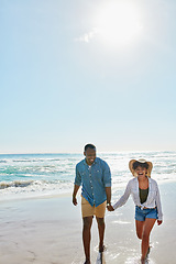 Image showing Happy, laughing and black couple holding hands at the beach for love, freedom and trust in Bali. Travel, smile and black man and woman walking by the ocean during a holiday for a date in summer