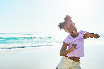 Image showing Children, beach and dance with a black girl having fun alone on the sand in summer by the sea or ocean. Nature, kids and blue sky with a female child dancing by the water while on holiday or vacation