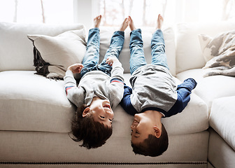 Image showing Children upside down, playing and happy at family home for fun with sibling, brothers on sofa and relax in living room. Happy people, love and quality time together, playful kid boys with laughing