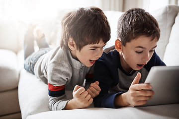 Image showing Children, movies and tablet streaming for playing esports game, gaming bonding or social media in family home. Brothers, boys and kids on digital technology in house living room with wow or surprise