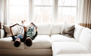 Image showing Fun children, bonding and reading books in education, learning or relax studying upside down on house living room or sofa. kids, storytelling and fantasy fairytale novel in creative home inspiration