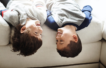 Image showing Children upside down, play and happy at family home, fun with sibling and face of brothers on sofa and relax in living room. Happy people, love and quality time together, playful kid boys and funny