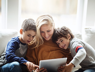 Image showing Love, tablet and mother with children on sofa bonding, quality time and relax on weekend together. Happy, family home and mom and kids with digital tech for online games, learning and internet app