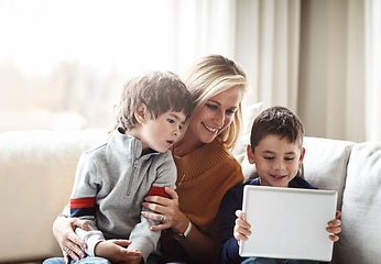 Image showing Relax, tablet and mother with children on sofa bonding, quality time and content on weekend. Love, family home and mom and kids with digital tech for online games, social media and streaming movies