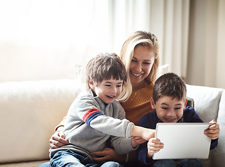 Image showing Family, tablet and mother with children on sofa bonding, quality time and relax on weekend together. Love, family home and mom and kids with digital tech for online games, learning and internet app