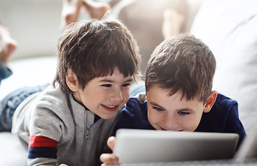 Image showing Happy children, bonding or tablet on relax house sofa in home living room on brothers esports, social media or movies. Smile, fun or kids streaming on digital technology in team education or learning