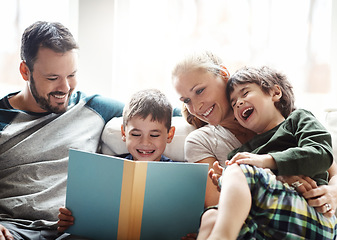 Image showing Family, books and couple reading with kids on sofa, laughing for happy storytelling time at home. Love, learning and child development, man and woman with children reading book on couch with smile.