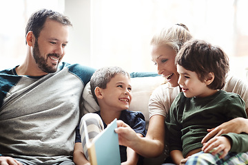 Image showing Mother, father and kids on sofa for storytelling time in living room of happy family home. Love, books and couple with children smile, book and fantasy story time on couch, growth and development.