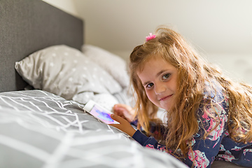 Image showing Little Girl watching movie On A Digital Tablet