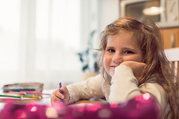 Image showing cute girl painting picture on paper