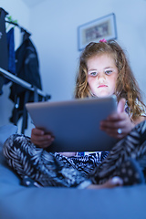 Image showing Little Girl watching movie On A Digital Tablet