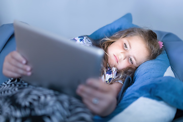 Image showing Little Girl watching movie On A Digital Tablet