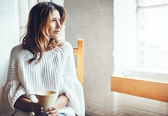 Image showing Relax, thinking and woman drinking coffee in her home, content and quiet while daydreaming on wall background. Tea, comfort and calm female enjoying peaceful morning indoors while looking out window