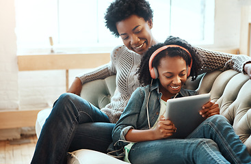 Image showing Black family, headphones and tablet to listen to music, streaming and online learning on lounge sofa. Woman or mother and teenager together in living room while happy about home wifi for education