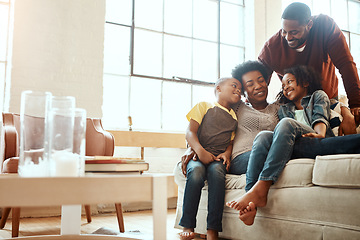 Image showing Love, black family and playful in living room, couch and bonding for quality time, loving and break. Mother, father and children on sofa in lounge, happiness and smile on weekend, playing and relax