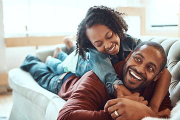 Image showing Black family, love and father with girl on sofa enjoying quality time, bonding and relax together on weekend. Living room, happiness and daughter embrace, hugging and laying with dad on couch at home