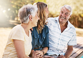 Image showing Fun, laughing and parents bonding with daughter at the pool to relax together in summer. Funny, happy and senior mother and father with a woman for quality time, peace and comic conversation