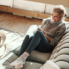 Image showing Phone, house couch and happy woman on the web in a living room calm on a social media scroll. Home sofa, lounge and person relax on a mobile online on wifi with a smile from streaming content