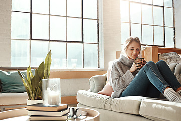 Image showing Woman relax in living room, coffee and peace on sofa, content at home with lifestyle and happiness. Female in apartment, happy woman and coffee cup, positive energy and mindset with wellness