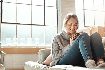 Image showing Woman on sofa, coffee and relax for happiness, break and on weekend for solitude, home and living room. Young female, girl or tea in lounge on couch, comfortable or smile with drink, house and casual