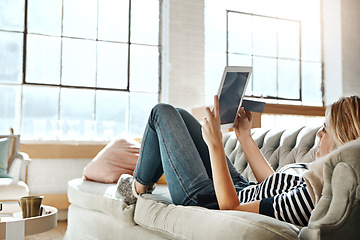 Image showing Woman, tablet and credit card for online shopping on sofa relaxing in the living room for ecommerce at home. Female shopper banking on touchscreen with bank card for purchase, app or sale on couch