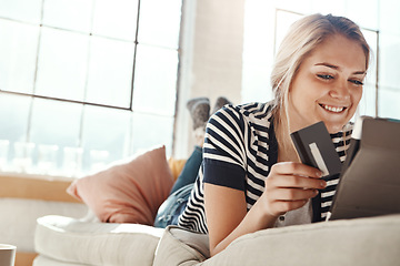 Image showing Online shopping, credit card and woman on tablet happy with online order payment in lounge. Relaxed girl on home sofa checking e commerce transaction for banking card with satisfied smile.