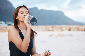 Image showing Beach, health and woman drinking water swimming in the sea while on summer vacation in Hawaii. Wellness, ocean and girl enjoying refreshing drink while relaxing on seaside holiday, trip or adventure.