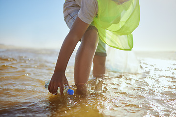 Image showing Plastic bottle, cleaning ocean and kid with environment and climate change, environmental and volunteer for Earth day. Water pollution, nature and children clean up beach for eco friendly activism