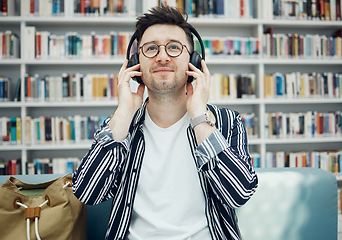 Image showing Library, student and man with music headphones in university, college or school. Education, learning scholarship and face of young male streaming educational podcast, radio or song, audio or album.